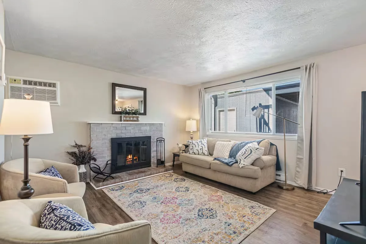 Sunny living room with sofa and fireplace
